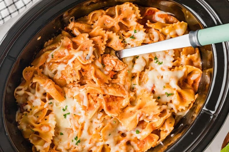 Creamy Chicken Pasta being mixed in the slow cooker.
