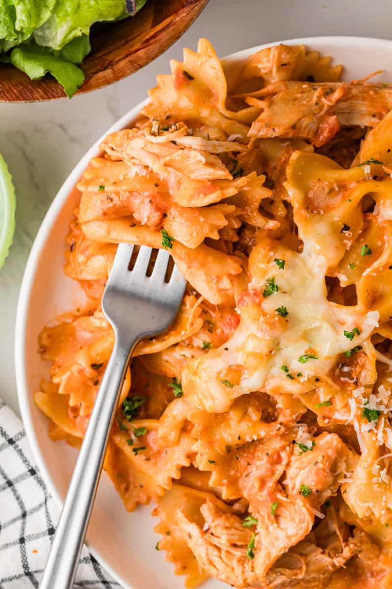 closeup of the Slow Cooker Creamy Chicken Pasta served on a white plate.