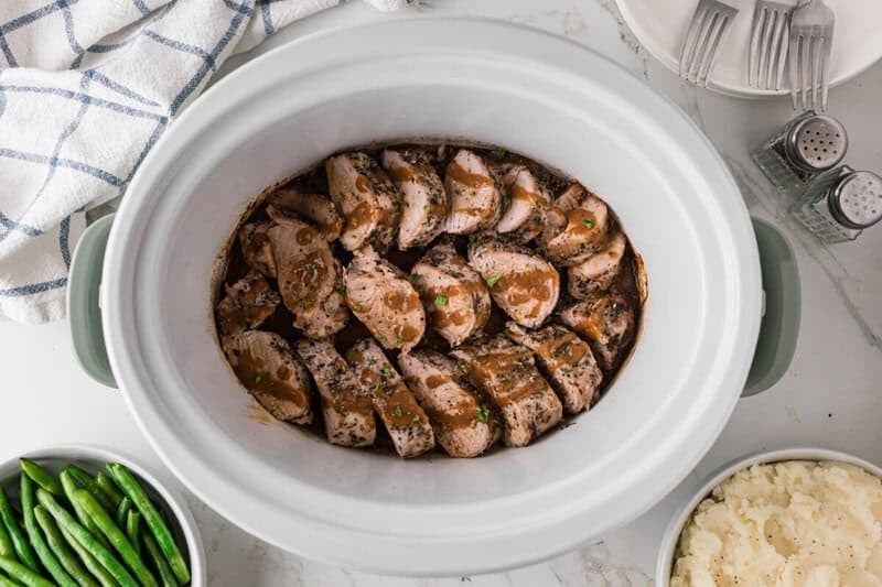 sliced pork loin in the slow cooker.