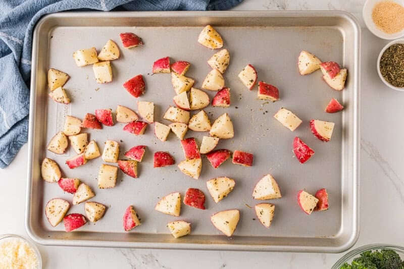 placing the potatoes on the sheet pan.