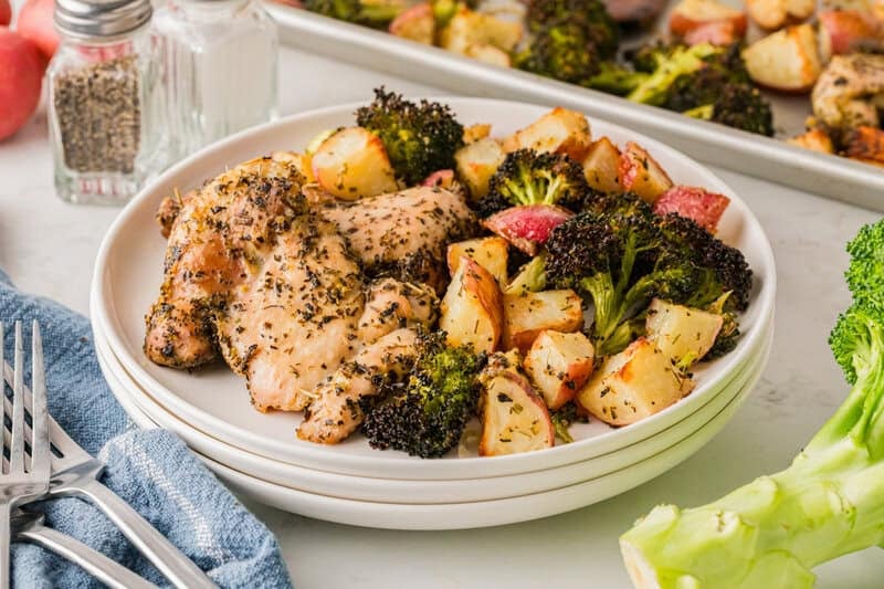 Sheet Pan Chicken served on white plates.