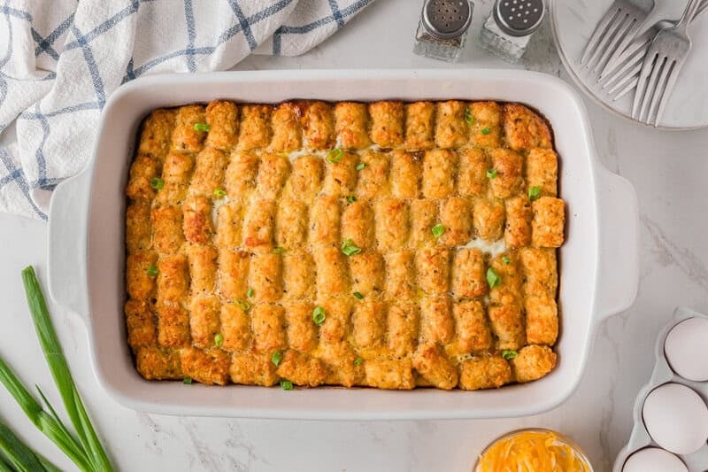 Tater Tot Breakfast Casserole baked in a white baking dish.