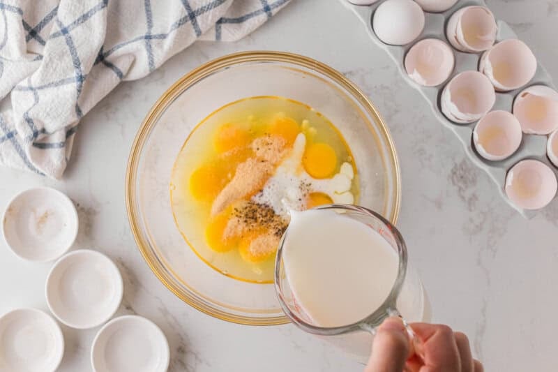 mixing together the eggs, milk and spices.