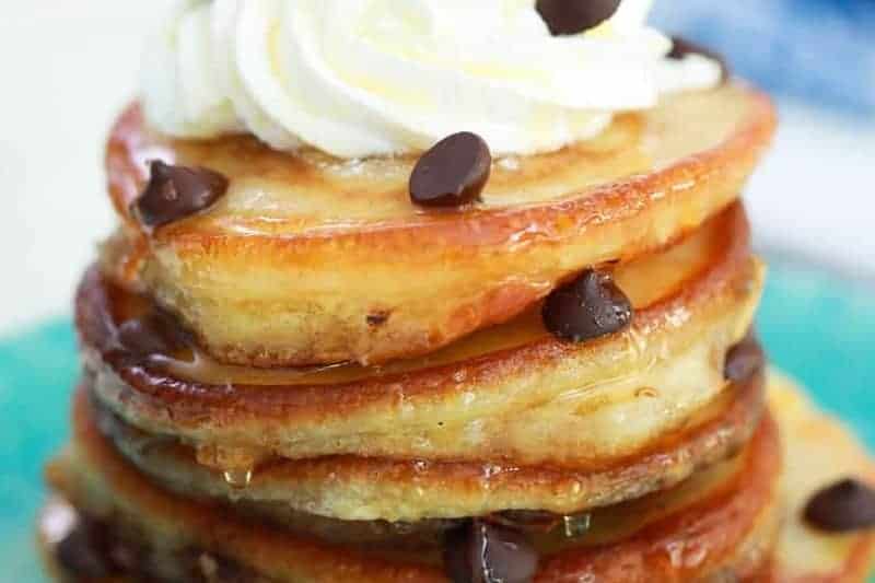 closeup of the Chocolate Chip Pancakes with whipped cream on top.