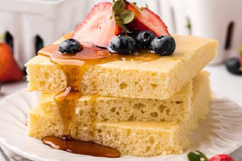 stack of the Sheet Pan Pancakes served on a white plate.