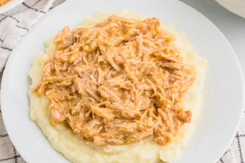 top-down view of the Slow Cooker Chicken and Gravy served on mashed potatoes.