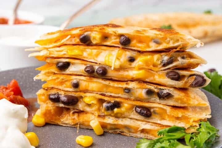 stack of the Black Bean Quesadillas served on a grey plate.