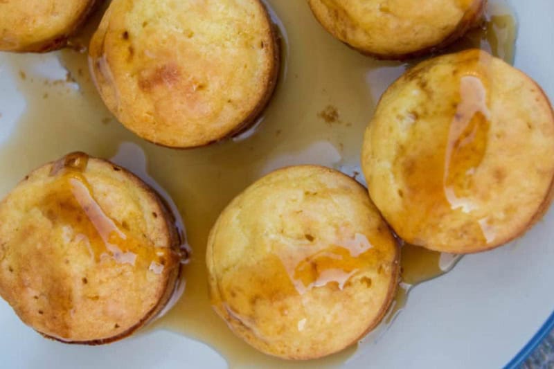 Pancake Mini Muffins served on a white plate with syrup.