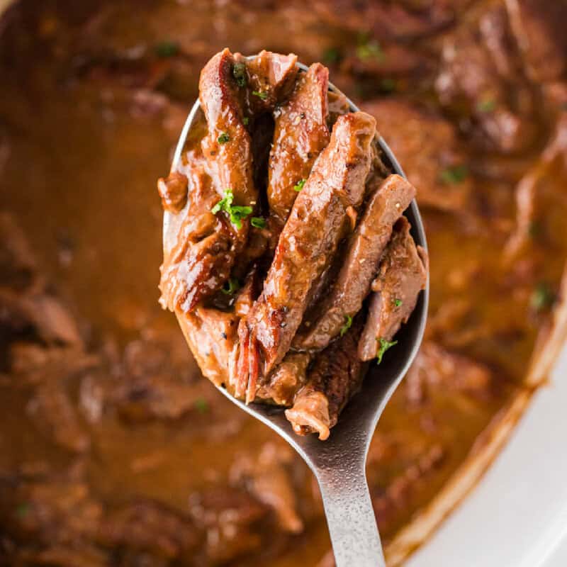 serving the steak and gravy out of the slow cooker with a metal spoon.