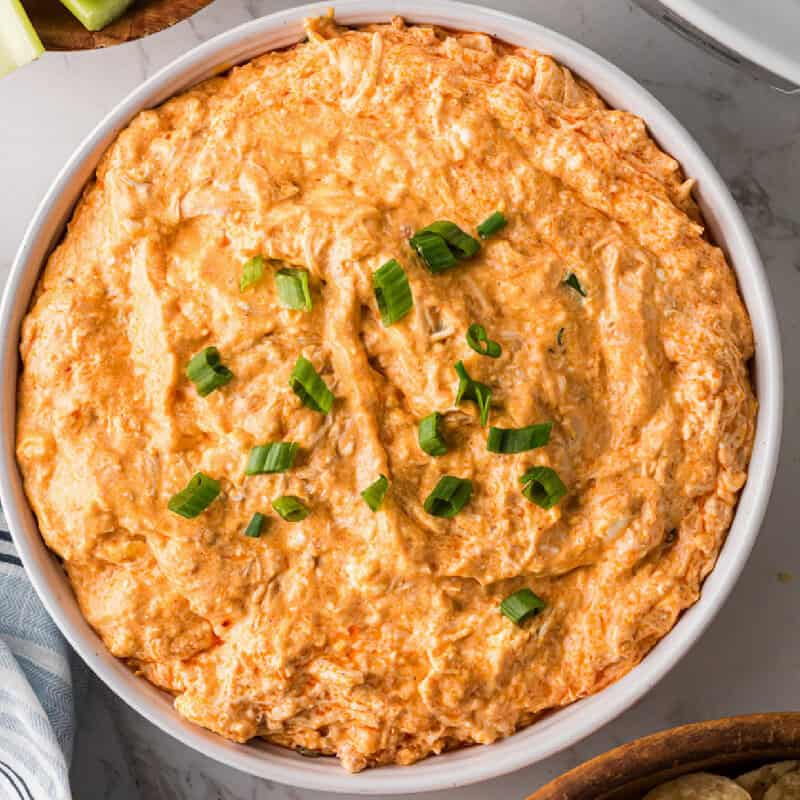 top-down closeup view of the Slow Cooker Buffalo Chicken Dip served in a white bowl.