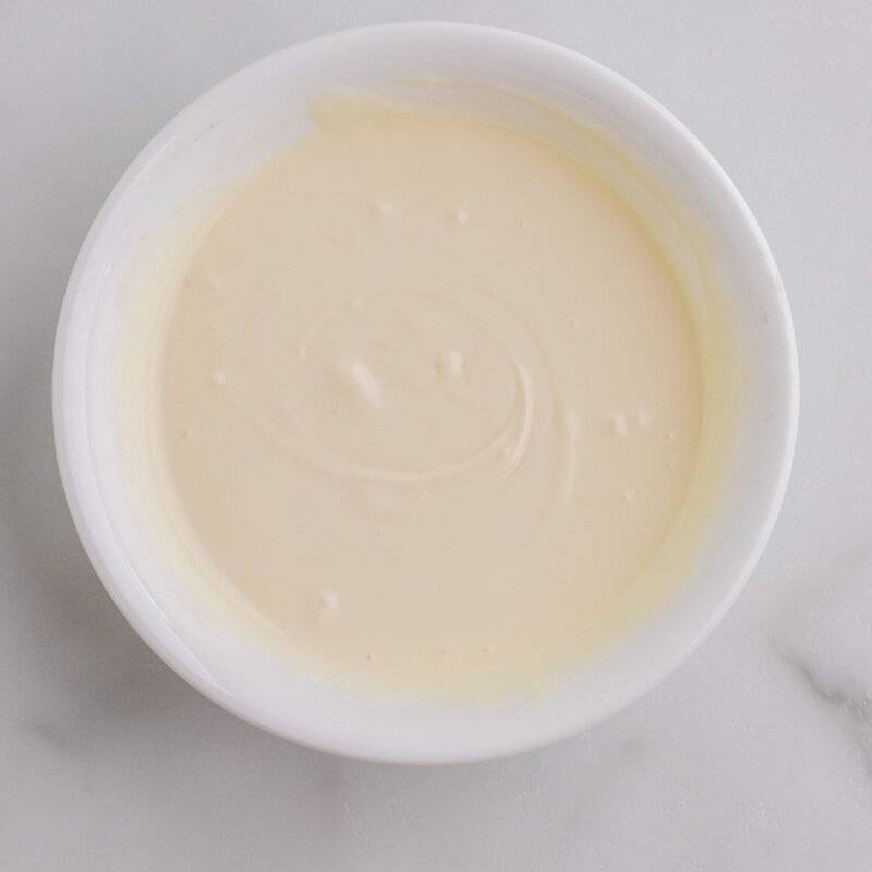 melted white chocolate in white bowl.