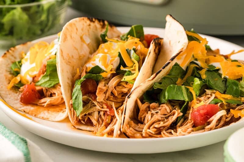 Chicken Tacos served on a white plate.