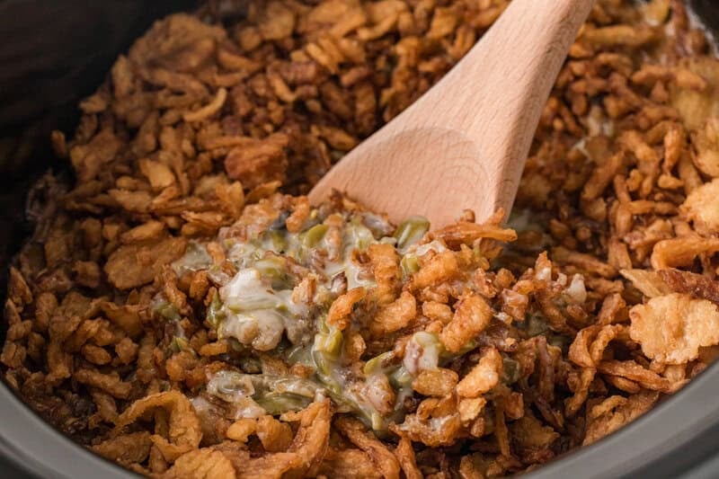 closeup of serving the Green Bean Casserole out of the slow cooker.