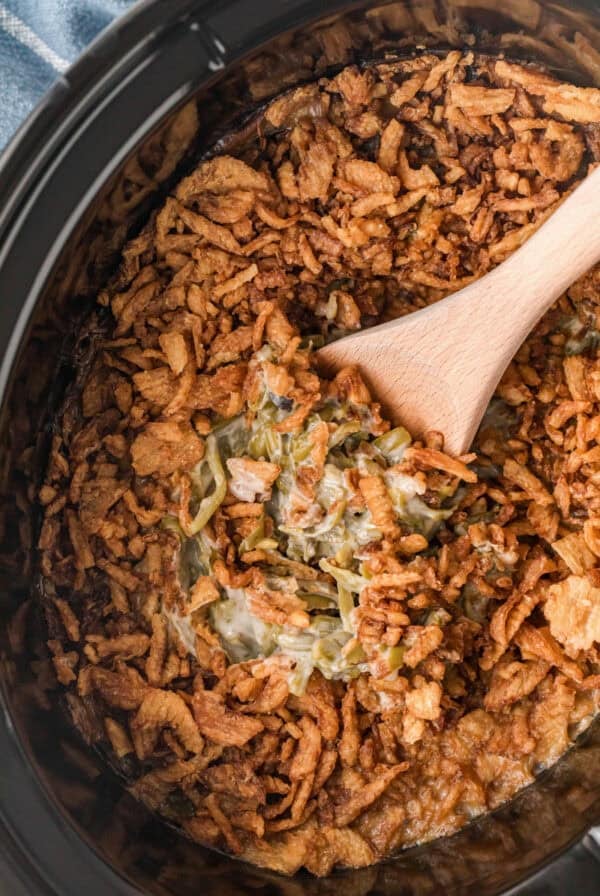 casserole in the slow cooker with wooden spoon