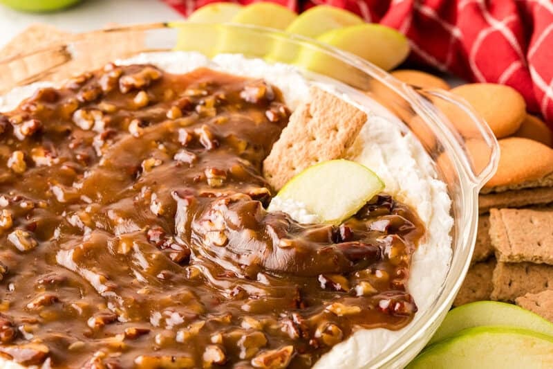 closeup of the Pecan Pie Dip with an apple and graham cracker in it.